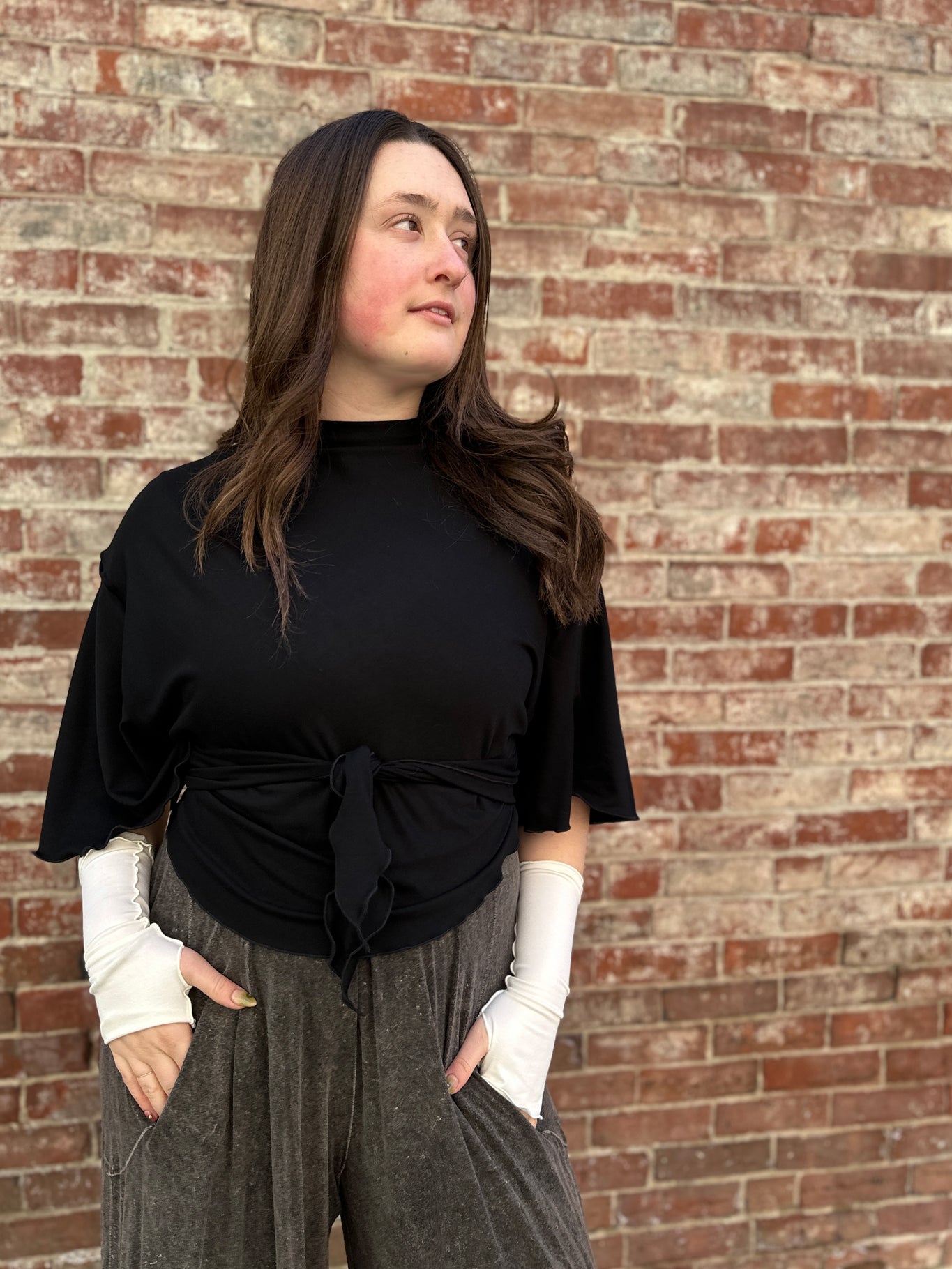 flutter summer jacket in black worn backwards and tied to front