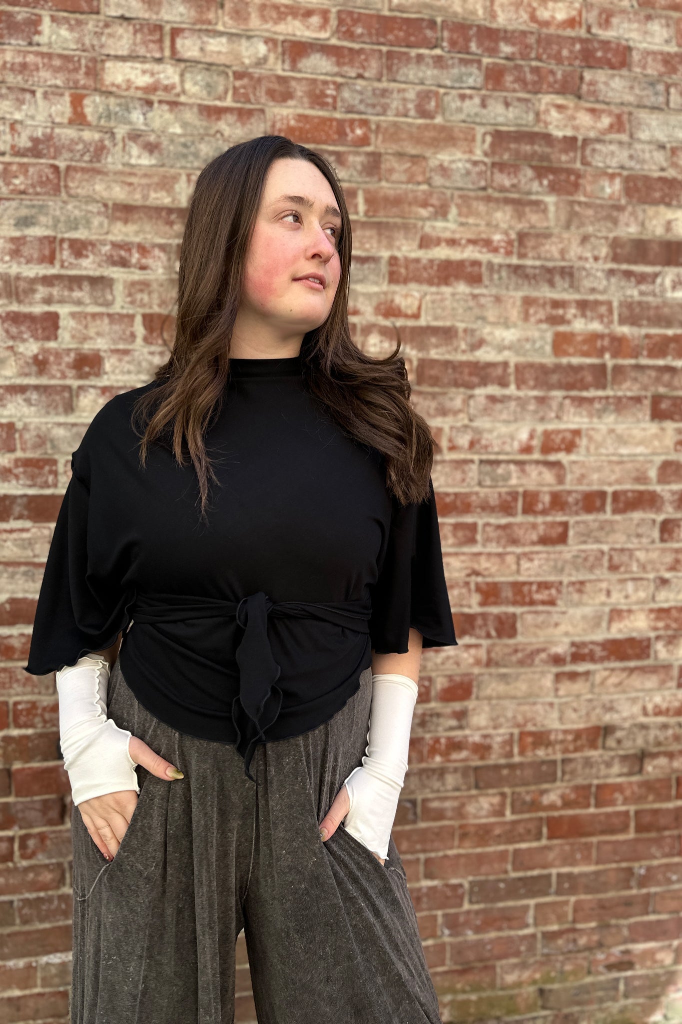 flutter summer jacket in black worn backwards and tied to front