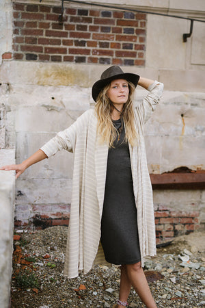 garden coat in dune over sheath dress in charcoal