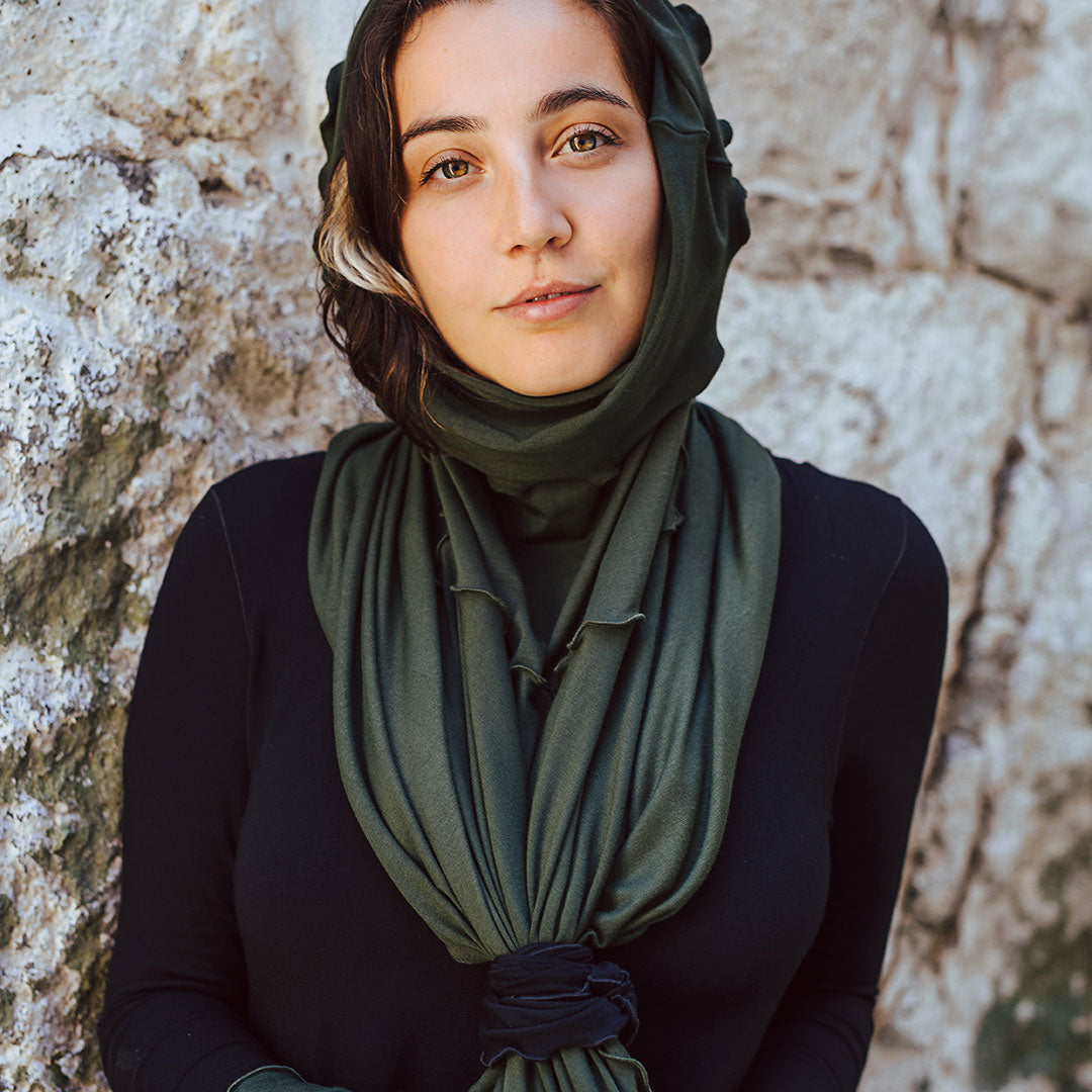 the band in black tying the flirt in fir into a headscarf