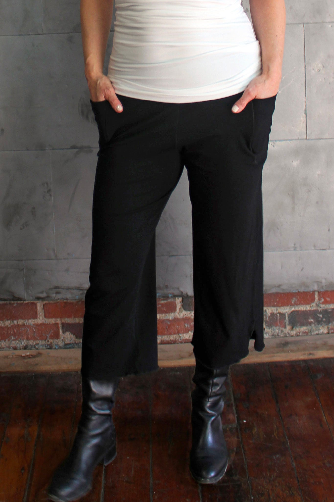 the black kick worn with a white wifey tank top