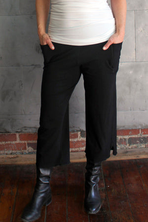 the black kick worn with a white wifey tank top