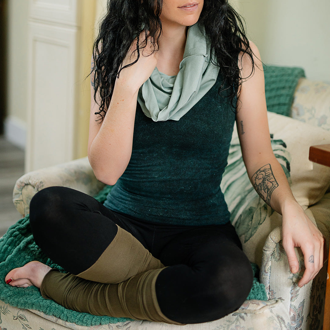 core tank in blue mineral with hourglass in glass, base legging in black, and stockings in olive