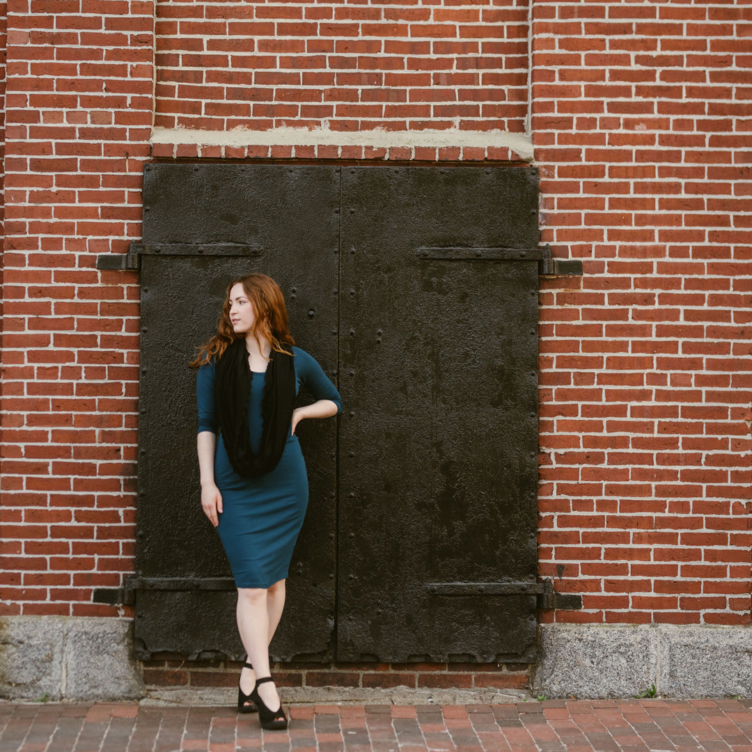 black loop worn over a lagoon noble dress