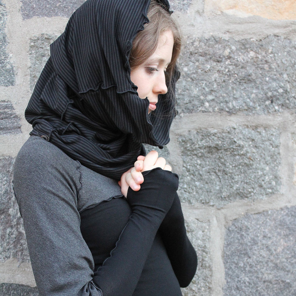 the hourglass hooded scarf in subtle stripe effortlessly accessorizes black and charcoal