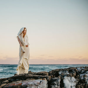milk loop scarf shawl paired with milk aria sleeves over a milk glow gown