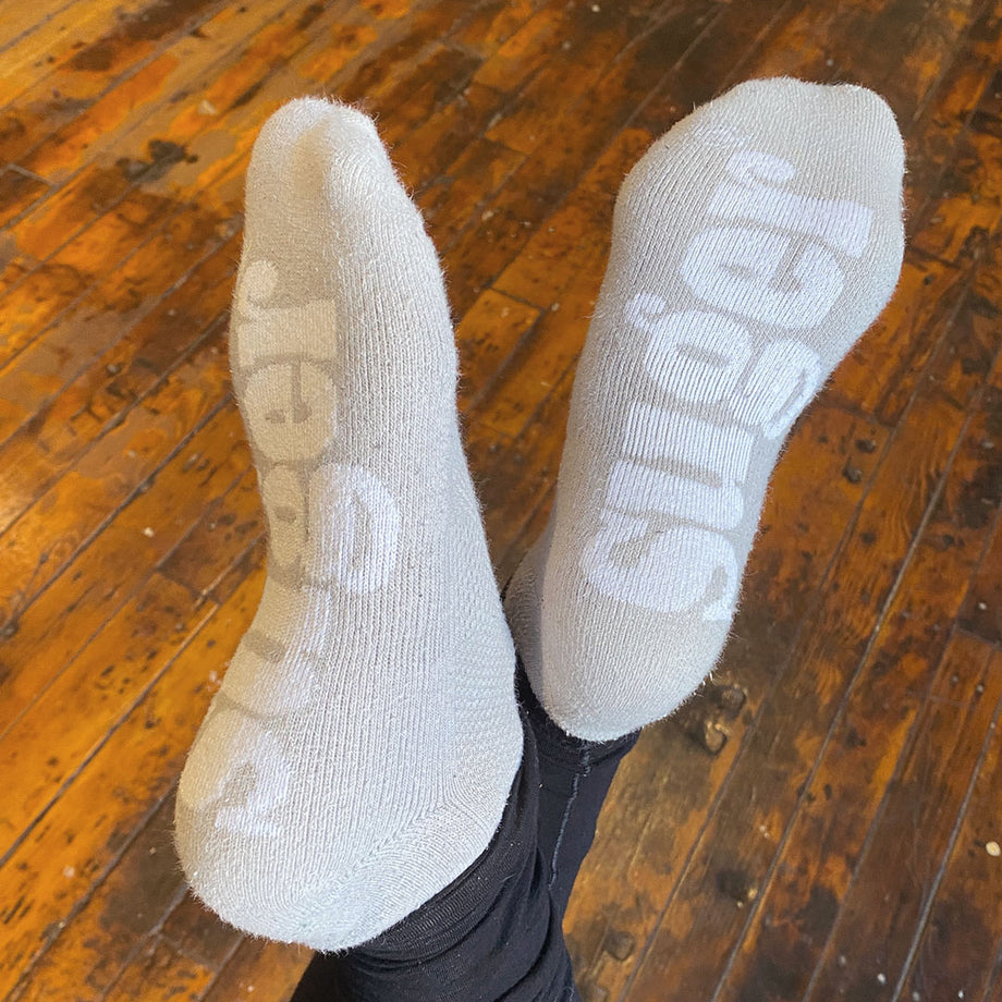 Used dirty socks on wooden floor Stock Photo
